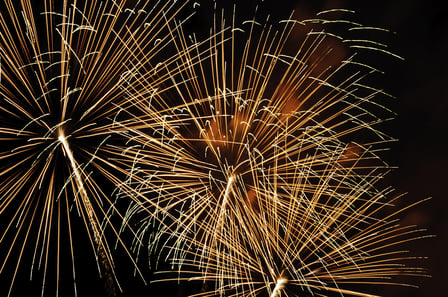 Intermingling of light trails from three bursts of fireworks